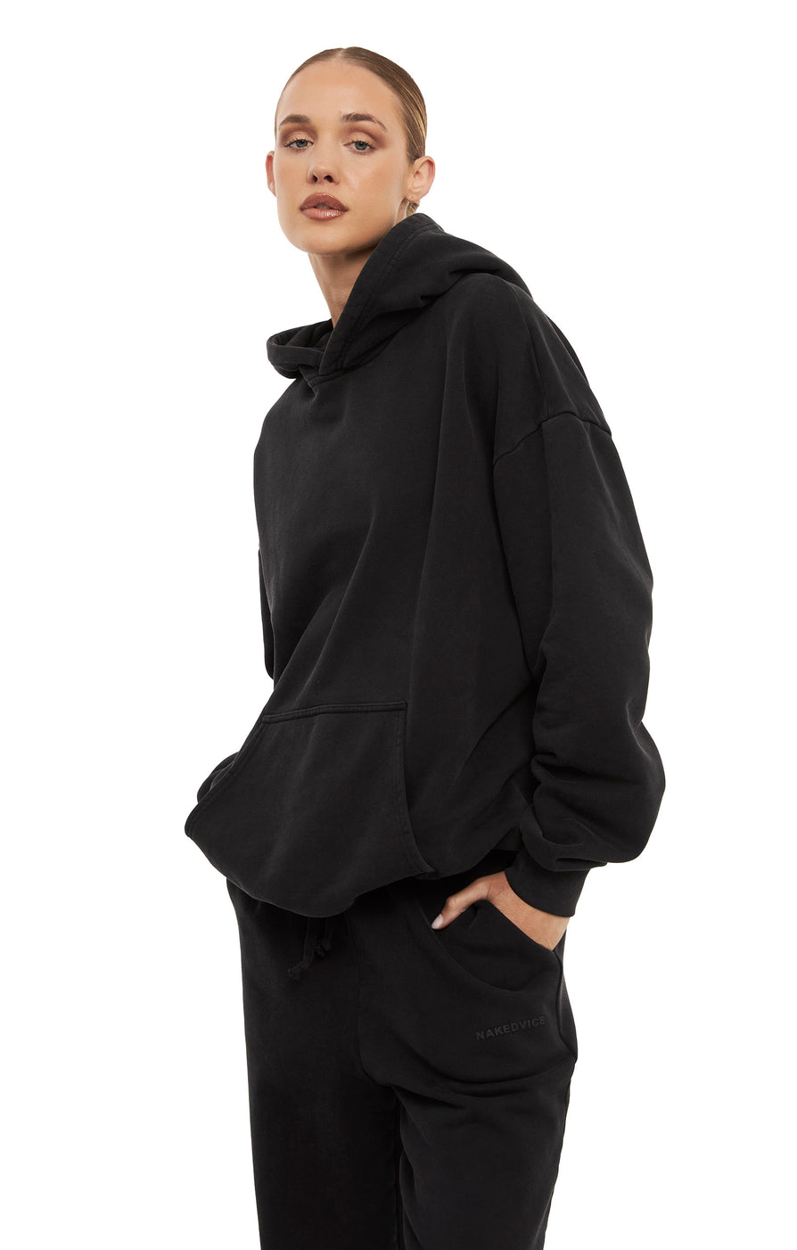 THE UNISEX WASHED BLACK HOODIE | model